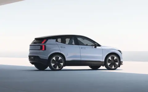 Jasnoszary Volvo EX30 z czarnym dachem i futurystycznymi felgami. Ten elektryczny SUV oferuje imponujący zasięg, idealny na długie podróże.